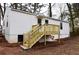 View of the back side of the house with newly constructed wooden stairs and deck at 3601 Orchard Cir, Decatur, GA 30032