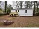 The spacious backyard with a brick fire pit and the rear of the home at 3601 Orchard Cir, Decatur, GA 30032