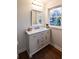 Bathroom vanity featuring a marble countertop, white cabinets, and a window view at 3601 Orchard Cir, Decatur, GA 30032