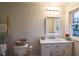 Bathroom vanity with marble countertop, mirror, and window view with natural light at 3601 Orchard Cir, Decatur, GA 30032