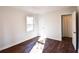 Bedroom featuring wood-look floors, white walls, and an open door to a bathroom at 3601 Orchard Cir, Decatur, GA 30032