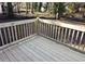 Corner view of the newly constructed wooden deck, showing the railings and bare wooded back yard at 3601 Orchard Cir, Decatur, GA 30032