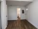 A living room with wood-look flooring, a bathroom view, and a white front door at 3601 Orchard Cir, Decatur, GA 30032