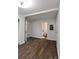 A living room with wood-look flooring, an open bathroom view, and white trim at 3601 Orchard Cir, Decatur, GA 30032