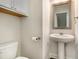 Bathroom features a pedestal sink, a sleek mirror, and modern fixtures at 1624 Venture Point Way, Decatur, GA 30032