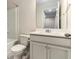 Bathroom features a vanity with storage, toilet, and shower/tub combination at 1624 Venture Point Way, Decatur, GA 30032