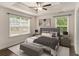 Comfortable bedroom showcasing tray ceilings, natural light, and a neutral color palette at 1624 Venture Point Way, Decatur, GA 30032