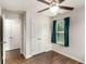 Bedroom with closet, ceiling fan and window with blinds, plus wood-look floors at 1624 Venture Point Way, Decatur, GA 30032