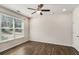 Bright bedroom features wood floors, ceiling fan, and large window allowing natural light at 1624 Venture Point Way, Decatur, GA 30032