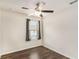 Cozy bedroom features a ceiling fan, a window with blinds, and wood-look floors at 1624 Venture Point Way, Decatur, GA 30032