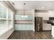 Open dining area with built-in cabinetry, modern lighting, and stainless steel refrigerator at 1624 Venture Point Way, Decatur, GA 30032