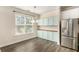 Dining area boasts ample natural light, stylish fixtures and stainless steel refrigerator at 1624 Venture Point Way, Decatur, GA 30032