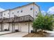 Exterior shot of a modern townhome with garages and decks at 1624 Venture Point Way, Decatur, GA 30032