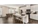 Modern kitchen features stainless steel appliances, white cabinetry, and a large center island with bar stools at 1624 Venture Point Way, Decatur, GA 30032