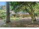 Expansive backyard with a hammock, brick patio, and lush greenery, offering a tranquil and inviting outdoor space at 3521 Eaglerock Dr, Atlanta, GA 30340