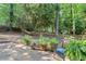 Serene backyard featuring a stone patio, hammock, and mature trees at 3521 Eaglerock Dr, Atlanta, GA 30340