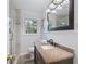 Bathroom featuring a vanity with granite counters, tiled shower, wood floors, and wainscoting at 3521 Eaglerock Dr, Atlanta, GA 30340