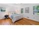 Well-lit bedroom with hardwood floors, neutral walls, and two large windows at 3521 Eaglerock Dr, Atlanta, GA 30340