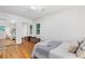 Well-lit bedroom features wood floors, sliding mirror closet, a bed with throw, and two windows at 3521 Eaglerock Dr, Atlanta, GA 30340