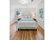 Bright bedroom boasts hardwood floors, a large bed, and natural light from exterior windows at 3521 Eaglerock Dr, Atlanta, GA 30340