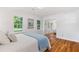 Light bedroom with sliding mirror closet, hardwood floors, and two large windows at 3521 Eaglerock Dr, Atlanta, GA 30340