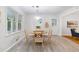 Sunlit dining area offers a round table with seating, large windows, and wood-look flooring at 3521 Eaglerock Dr, Atlanta, GA 30340