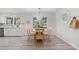 Inviting dining area showcases a round table, natural light, and stylish wood-look flooring at 3521 Eaglerock Dr, Atlanta, GA 30340