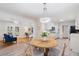 Bright dining area features a round table with seating for four, decorative lighting, and beautiful gray wood-look floors at 3521 Eaglerock Dr, Atlanta, GA 30340