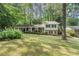 Beautiful home with a lush green lawn, mature trees, and charming blue shutters at 3521 Eaglerock Dr, Atlanta, GA 30340