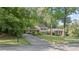 Lovely home featuring a long driveway, well-maintained lawn, and mature trees for added privacy at 3521 Eaglerock Dr, Atlanta, GA 30340