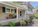 Charming brick home featuring a welcoming front porch with flower decor and colorful flowerpots at 3521 Eaglerock Dr, Atlanta, GA 30340