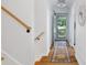 Bright hallway with wooden floors, neutral walls, runner rug, and view to the outdoors at 3521 Eaglerock Dr, Atlanta, GA 30340