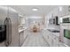 Spacious kitchen features stainless steel appliances, white cabinets, stone countertops, and view into the dining area at 3521 Eaglerock Dr, Atlanta, GA 30340
