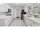 Modern kitchen features white cabinetry, stainless steel appliances, stone countertops, and tile backsplash at 3521 Eaglerock Dr, Atlanta, GA 30340