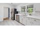 Bright kitchen features stainless steel appliances, quartz countertops, and beautiful wood-look flooring at 3521 Eaglerock Dr, Atlanta, GA 30340