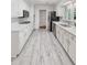 Well-lit kitchen features modern appliances, tile backsplash, stone countertops, and gray tile flooring at 3521 Eaglerock Dr, Atlanta, GA 30340