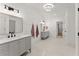 Elegant bathroom with double vanity, marble countertops, and tiled floor at 3805 Carder Ln, Cumming, GA 30028