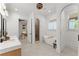 Bright bathroom with a soaking tub, dual sink vanity, and open access to the shower and bedroom at 3805 Carder Ln, Cumming, GA 30028
