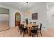 Bright dining room with modern lighting, wooden table, and stainless steel appliances at 3805 Carder Ln, Cumming, GA 30028