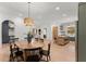 Bright dining room with modern lighting, wooden table, and an open floor plan at 3805 Carder Ln, Cumming, GA 30028