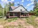 Inviting exterior featuring a spacious covered porch and outdoor seating area at 3805 Carder Ln, Cumming, GA 30028