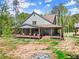 Gorgeous home boasting a covered porch, outdoor seating, and a peaceful setting at 3805 Carder Ln, Cumming, GA 30028