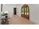 Bright foyer with wood-look floors and a view of the arched double doors leading outside at 3805 Carder Ln, Cumming, GA 30028