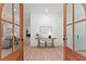 Inviting foyer showcasing wood-look floors and a decorative table viewed through arched double doors at 3805 Carder Ln, Cumming, GA 30028