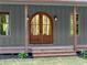 Charming entrance featuring a beautiful arched wood double door and a welcoming front porch at 3805 Carder Ln, Cumming, GA 30028