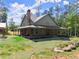 Home has a covered porch with stone accents; partially sodded yard and stone accents at 3805 Carder Ln, Cumming, GA 30028