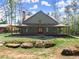 Home features a covered porch with stone accents; sodded yard at 3805 Carder Ln, Cumming, GA 30028
