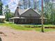 Inviting home with covered porch, stone chimney, and a well-maintained yard at 3805 Carder Ln, Cumming, GA 30028