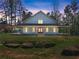 Charming exterior with a covered front porch, lots of windows, and stone landscaping at 3805 Carder Ln, Cumming, GA 30028