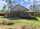Home features a covered porch that wraps around the side, overlooking the landscaping at 3805 Carder Ln, Cumming, GA 30028